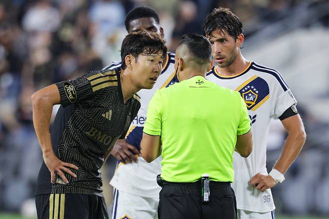 Los Angeles FC forward Son Heung-min, left, speaks with the referee during an MLS match against the LA Galaxy at BMO Stadium in Los Angeles on Oct. 25. EPA/YONHAP