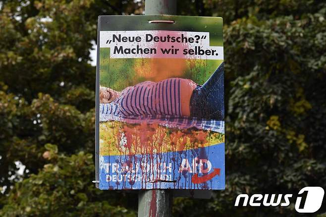 독일을위한대안(AfD) 선거 포스터에 빨간 스프레이가 뿌려져 있다. 포스터엔 임신한 여성의 사진과 "새로운 독일인? 우리가 스스로 만들자"라는 글귀가 적혀 있다. © AFP=뉴스1