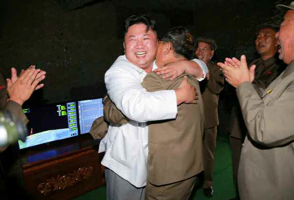 김정은 노동당 위원장이 지난해 8월24일 SLBM 수중 시험발사에 성공한 뒤 관계자들과 함께 기뻐하고 있다.    연합뉴스