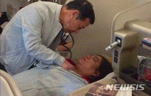 【광주=뉴시스】송창헌 기자 = 의사 출신 윤장현 광주시장이 2일 오전 인천발 미국 LA행 아시아나항공 비행기안에서 60대 베트남 여성을 응급처치하고 있다. 2018.05.02 (사진=윤장현 시장 페이스북) photo@newsis.com