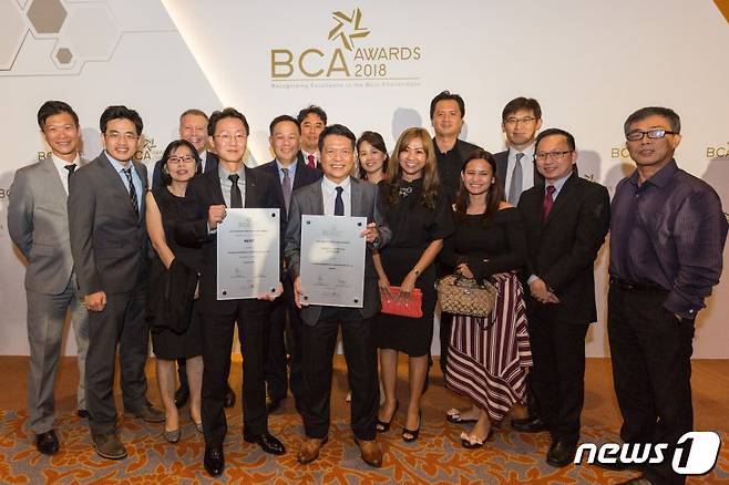 싱가포르 리조트 월드 센토사에서 열린 'BCA AWARDS 2018' 시상식. 김항열 싱가포르 지사장(왼쪽 7번째), TAN BOON LANG, FREDDY 상무(왼쪽 8번째) 등 현대건설 임직원들이 싱가포르 건설대상을 수상한 뒤 기념촬영을 하고 있다.© News1