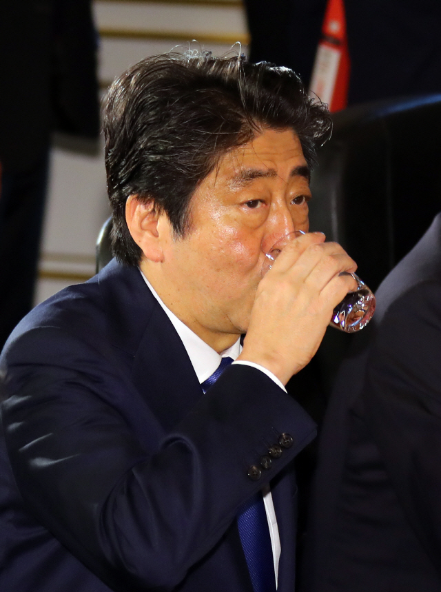 아베 신조 일본 총리가 지난 9일 오전 일본 도쿄 영빈관 ‘하고로모노마’에서 열린 제7차 한·일·중 정상회의에서 발언하기 앞서 물을 마시며 목을 축이고 있다. / 연합뉴스