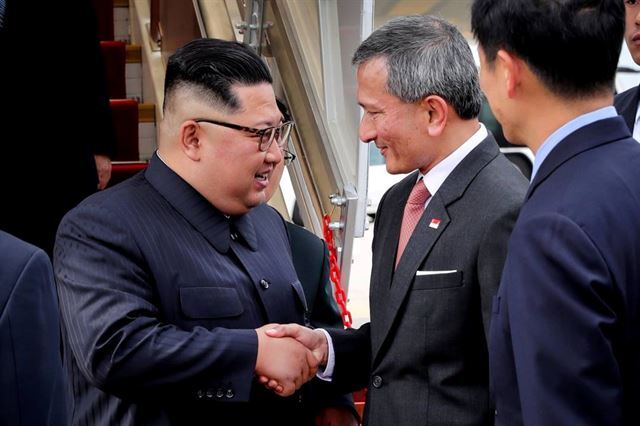 김정은 북한 국무위원장이 10일 오후(현지시간) 싱가포르 창이 공항에서 비비안 발라크리쉬난 싱가포르 외무장관의 영접을 받고 있다. 싱가포르 공보부 제공 사진
