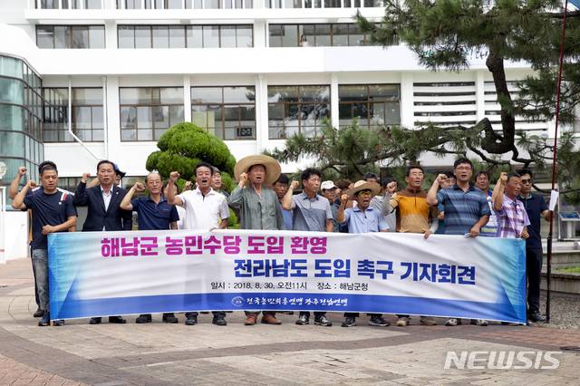 【해남=뉴시스】박상수 기자 = 전국농민회총연맹 광주전남연맹 회원들이 30일 해남군청 앞 광장에서 해남군의 농민수당 도입 환영과 전남도의 도입을 촉구하는 기자회견을 갖고 있다. 2018.08.30. (사진=농민회 제공) photo@newsis.com