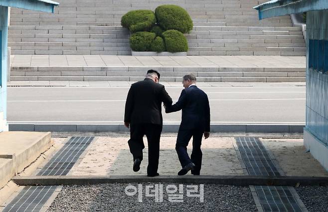 지난 4월 27일 판문점 남북정상회담에서 문재인 대통령이 북한 김정은 국무위원장의 손을 잡고 군사분계선(MDL) 표식인 높이 50cm의 콘크리트 둔턱을 넘어 북측으로 향하고 있다. 한국공동사진기자단