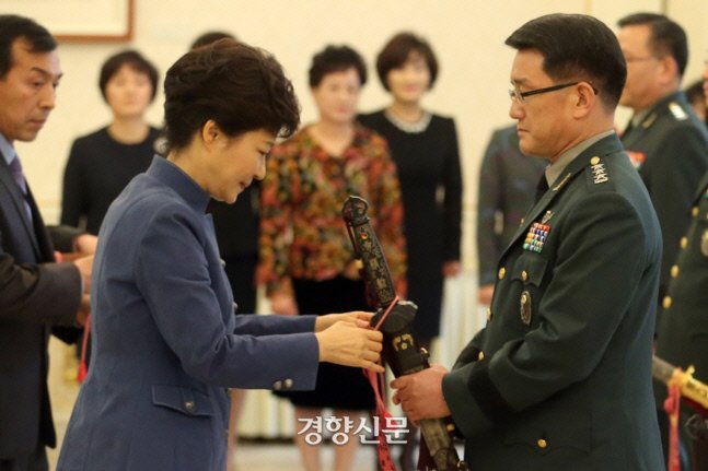박근혜 전 대통령이 2013년 11월 15일 청와대에서 열린 군 장성 수치 수여식에서 이재수 당시 신임 국군 기무사령관의 삼정도에 수치를 달아주고 있다./연합뉴스