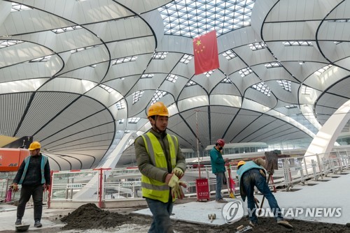 지난 20일 베이징 다싱공항 건설현장에서 노동자들이 작업하고 있다. [로이터=연합뉴스]