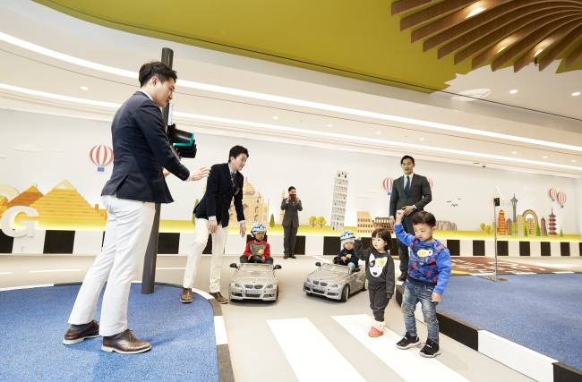 Children have fun driving and learning about road safety at the BMW Kids Driving Zone in Paradise Hotel Busan. / Paradise Hotel Busan