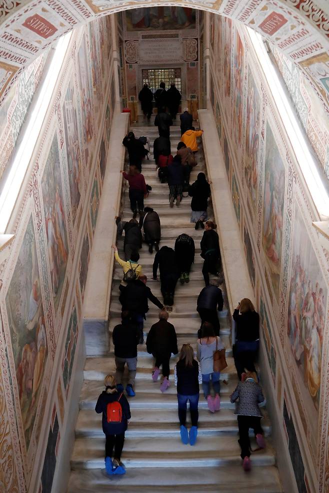 신자들이 지난 16일(현지시간) 새롭게 복원된 로마 '성 계단'을 무릎으로 오르고 있다. [로이터=연합뉴스]