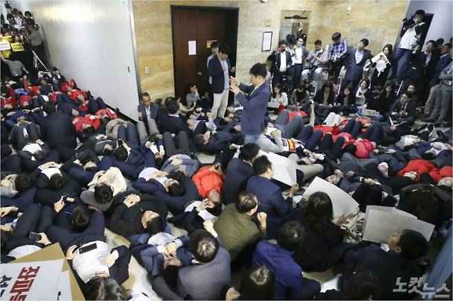 자유한국당 의원들이 29일 오후 서울 여의도 국회 행정안전위원회 복도에서 정의당 이정미 대표를 비롯한 의원들이 지나가지 못하게 누워서 길을 막고 있다. 윤창원기자