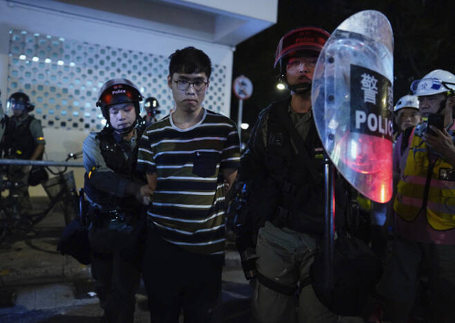 21일 홍콩 경찰이 이날 시위에 가담한 한 남성을 연행하고 있다.                                                                               사진｜AP·연합뉴스