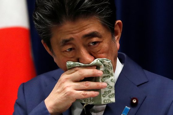 아베 신조 일본 총리가 28일 총리관저에서 신종 코로나 대책 관련 기자회견을 하는 도중 손수건으로 코 주변을 닦고 있다. [로이터=연합뉴스]
