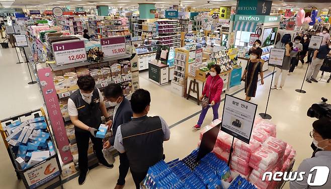 24일 오후 서울 성동구 이마트 성수점에서 비말차단용 마스크를 구매하려는 시민들이 번호표와 마스크를 맞바꾸고 있다. 2020.6.24/뉴스1 © News1 이승배 기자
