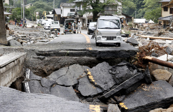 일본 폭우 피해 확산… 파괴된 도로 - 지난 11일 일본 남부 오이타현 히타지역에서 쏟아진 폭우로 도로가 붕괴돼 있다. 일본은 주말 폭우로 인한 홍수와 산사태 속에 실종된 사람들을 여전히 수색하고 있다.AP 연합뉴스 2020-07-12