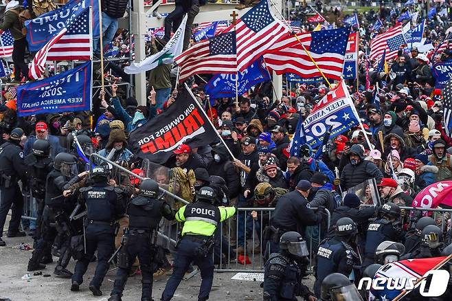 6일(현지시간) 도널드 트럼프 미국 대통령을 지지하는 시위대가 워싱턴 의사당으로 몰려들면서 경찰과 충돌하고 있다. © AFP=뉴스1 © News1 우동명 기자