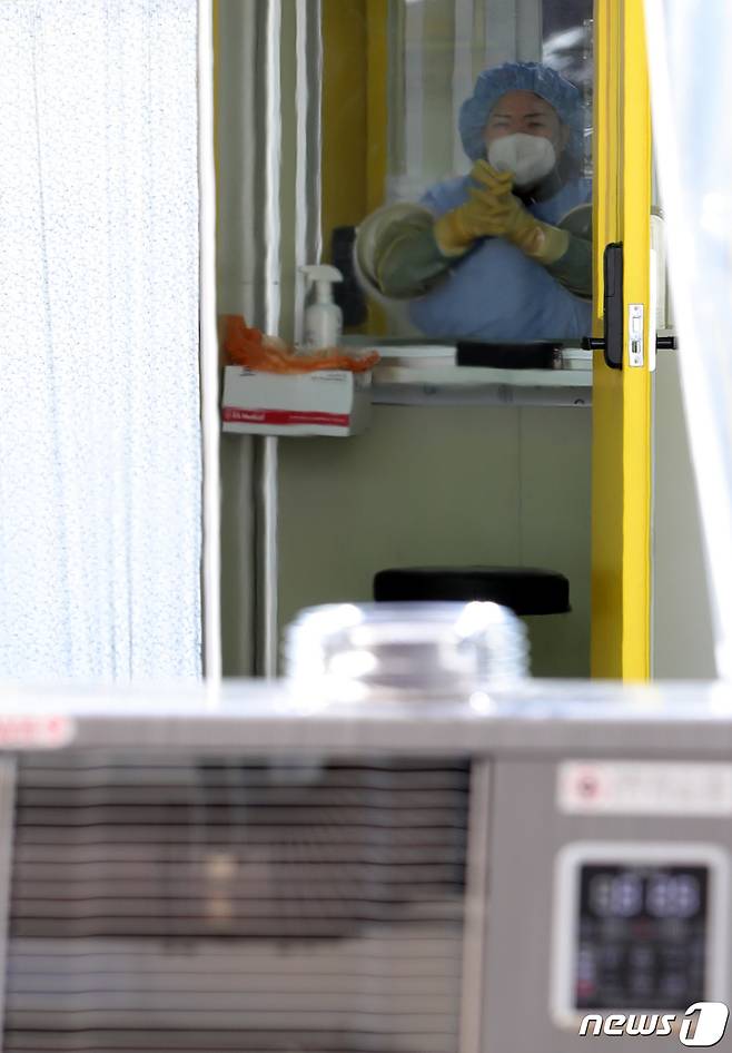 북극한파가 절정에 이르며 올 겨울 가장 추운 날씨를 보인 8일 전북 전주시 덕진 선별진료소에서 한 의료진이 손을 비비며 추위를 녹이고 있다. 2021.1.8/뉴스1 © News1 유경석 기자