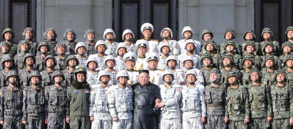 김정은 북한 노동당 총비서가 지난 16일 제8차 당 대회 기념 열병식 참가자들과 기념촬영을 하고 있다. 뉴스1
