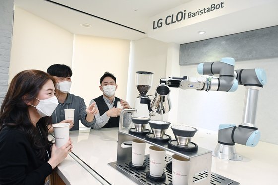 서울 영등포구 LG트윈타워에 설치된 'LG 클로이 바리스타봇'을 이용하는 임직원들. LG전자 제공