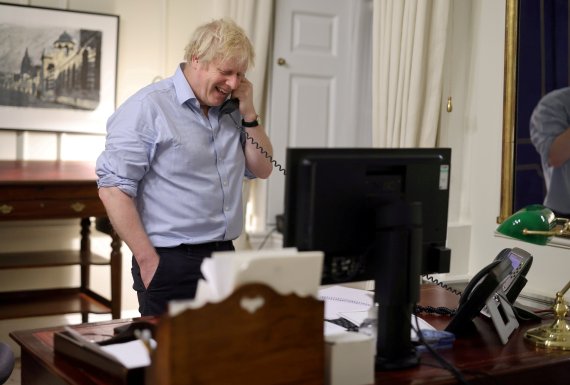 보리스 존슨 영국 총리가 23일(현지시간) 런던 총리관저에서 조 바이든 미국 대통령으로부터 걸려온 전화를 받고 있는 모습. 다우닝가에서 사진을 공개했다.로이터뉴스1