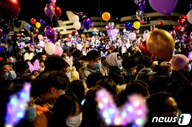코로나19 진원지인 중국 후베이성 우한에서 새해 카운트다운 행사에 참석한 마스크를 쓴 시민들이 붐비고 있다. © AFP=뉴스1 © News1 우동명 기자