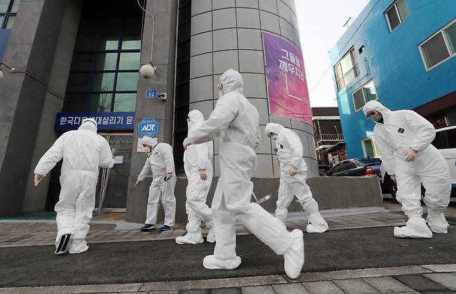 Disease officials are work Monday to carry out disinfection and restrict access at the IEM School in Daejeon. (Yonhap)