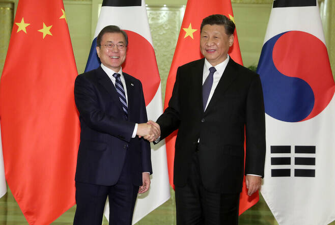 South Korean President Moon Jae-in shakes hands with Chinese President Xi Jinping in Beijing on Dec. 23, 2019. (Blue House photo pool)
