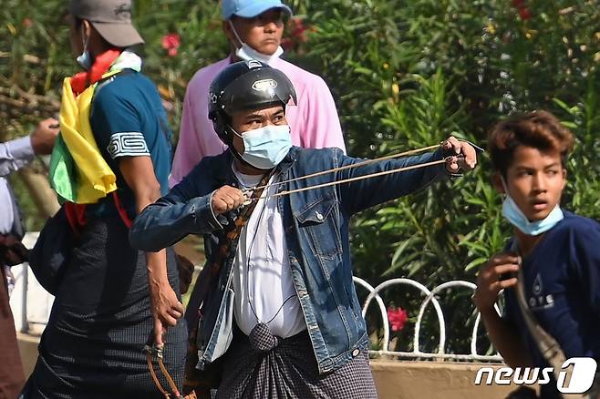 미얀마 양곤 등지에서 2021년 2월 25일 군정 지지자들이 등장해 새총과 칼, 파이프 등을 사용하며 시위대와 충돌했다. © AFP=뉴스1