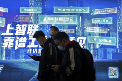 마스크를 쓴 중국 베이징 시민들이 지난 2일 스마트폰을 보면서 지하철 전광판 앞을 지나가고 있다. /AP연합뉴스