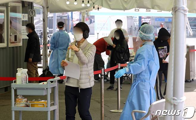 20일 오후 서울 중구 서울역 광장에 마련된 임시 선별검사소에서 시민들이 코로나19 검사를 받고 있다. 2021.4.20/뉴스1 © News1 조태형 기자