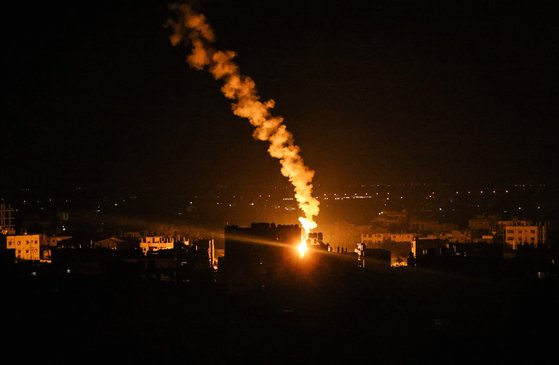 16일(현지시간) 새벽 팔레스타인 자치 지역인 가자지구 남부 라파 마을 상공에서 이스라엘군이 발사한 폭탄이 터지고 있다. [AFP=연합뉴스]