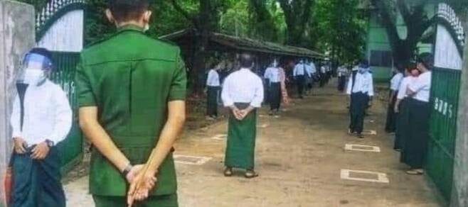 학교 정문에서 회초리를 들고 있는 미얀마 군 장교 [이라와디 사이트 캡처. 재판매 및 DB 금지]