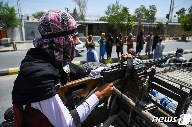 16일(현지시간) 아프가니스탄 정권을 재장악한 탈레반 전사가 카불 거리에서 기관총을 장착한 차량을 타고 순찰을 하고 있다. © AFP=뉴스1 © News1 우동명 기자