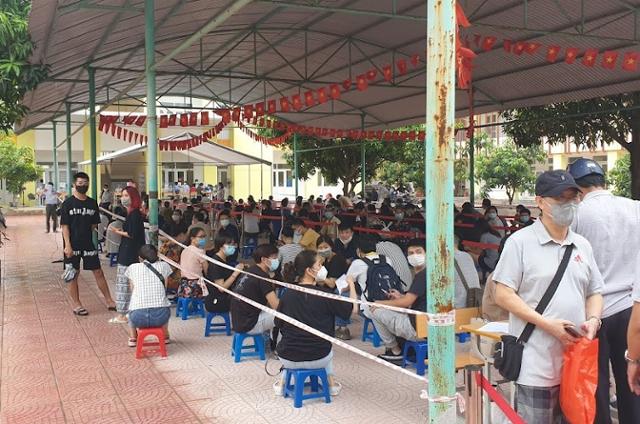 지난달 15일 베트남 수도 하노이의 시민들이 코로나19 백신을 접종하기 위해 칸막이도 설치되지 않은 공립학교 운동장에서 긴 줄을 서 대기하고 있다. 하노이=정재호 특파원