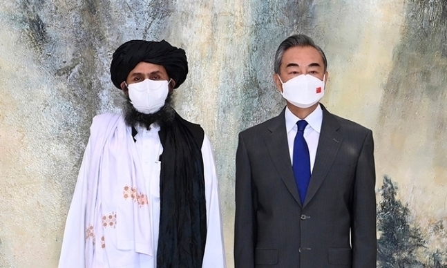왕이 중국 외교 담당 국무위원 겸 외교부장(오른쪽)이 지난 7월28일(현지시간) 톈진에서 방중 중인 아프가니스탄 무장조직 탈레반의 2인자 물라 압둘 가니 바라다르(왼쪽)와 기념 사진을 찍고 있다. 톈진=신화연합