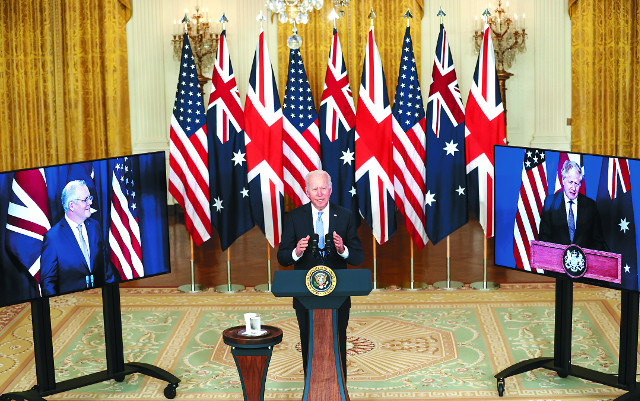 조 바이든 미국 대통령이 15일(현지시간) 워싱턴 백악관 이스트룸에서 화상으로 연결된 스콧 모리슨 호주 총리, 보리스 존슨 영국 총리와 함께 오커스(AUKUS) 파트너십 체결을 발표하고 있다. 3국은 오커스의 첫 구상으로 호주의 핵추진 잠수함 보유를 지원키로 했다. EPA연합뉴스