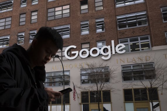 구글이 21일(현지시간) 미국 뉴욕 맨해튼의 허드슨강 인근 '세인트존스 터미널' 건물을 21억달러에 사들이기로 했다고 밝혔다. 2018년 12월 17일 구글 뉴욕 사무실 앞을 한 청년이 걸어나고 있다. FILE - In this file photo dated Monday, Dec. 17, 2018, a man using a mobile phone walks past Google offices in New York. Google is planning to buy New York's St. John’s Terminal for $2.1 billion, making it the anchor of its Hudson Square campus. Alphabet and Google Chief Financial Officer Ruth Porat said Tuesday, Sept. 21, 2021, that the company is looking to invest more than $250 million in its New York campus this year. (AP Photo/Mark Lennihan, FILE) /뉴시스/AP /사진=뉴시스 외신화상