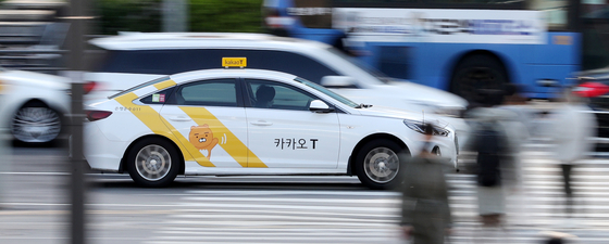 A taxi registered with Kakao T, a mobility affiliate of Kakao, drives on the road in central Seoul. [NEWS1]
