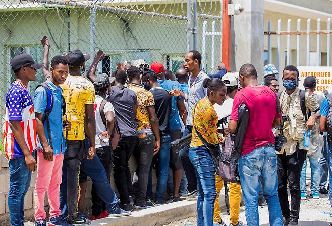 미국 당국에 의해 텍사스를 떠나 22일 아이티 포르토프랭스 공항에 도착한 아이티 난민들이 입국 수속을 기다리고 있다. 로이터=연합뉴스