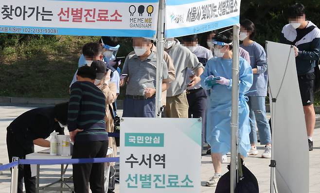 24일 오전 서울 강남구 SRT수서역에 마련된 찾아가는 선별진료소에서 시민들이 코로나19 검사를 받기 위해 줄지어 서있다. 연합뉴스