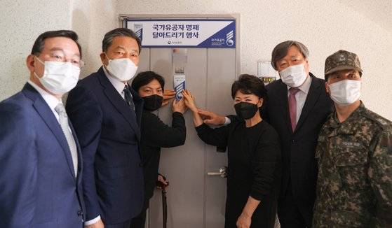 지난 3월 10일 황기철 국가보훈처장(왼쪽 둘째)이 '서해수호의 날'을 맞아 인천시 부평구에 있는 천안함 국가유공자 신은총 하사 자택을 방문해 국가유공자 명패를 달고 기념 촬영을 하고 있다. 지팡이로 몸을 지탱한 신 하사와 신 하사의 어머니가 황 처장 등과 함께 명패를 잡고 있다. 국가보훈처