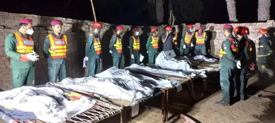 지난 17일(현지시간) 파키스탄에서 구조대원들이 무자파가르에서 화재로 숨진 희생자들의 시신을 수습하고 있다. 로이터=연합뉴스