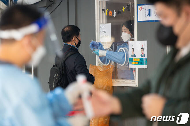 22일 서울역광장에 마련된 신종 코로나바이러스 감염증(코로나19) 중구 임시선별검사소를 찾은 시민들이 검체채취를 하고 있다.  2021.10.22/뉴스1 © News1 유승관 기자