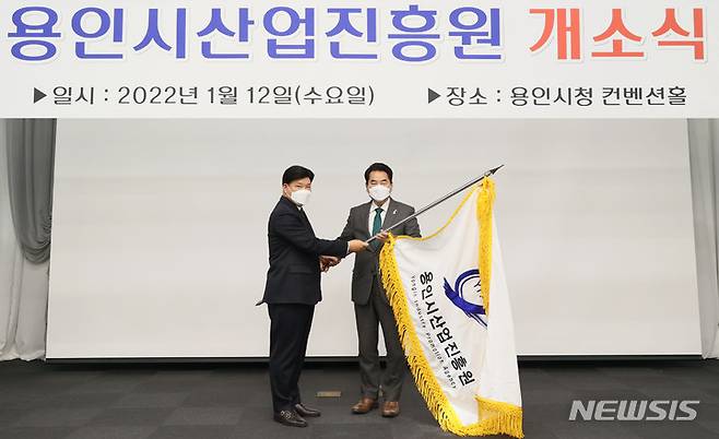 [용인=뉴시스]백군기 용인시장이 12일 김윤석 용인시산업진흥원장에게 깃발을 전달하고 있다.