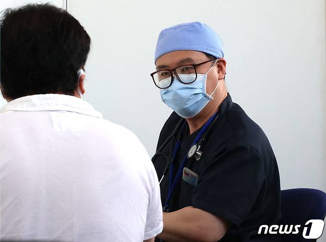 일본의 한 남성이 신종 코로나바이러스 감염증(코로나19) 백신을 접종하기 전 의사의 진료를 받고 있다. © AFP=뉴스1