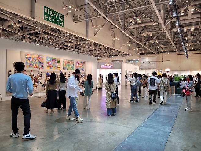 Visitors to Art Busan 2022 view David Hockney’s photographic drawing “Pictures at an Exhibition” on Friday at the GRAY's booth at Art Busan in Busan. (Park Yuna/The Korea Herald)