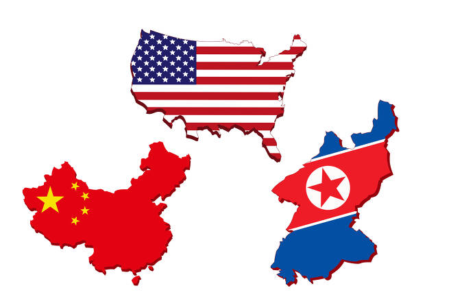 Chinese, US and North Korean flags (from left to right). (123rf)