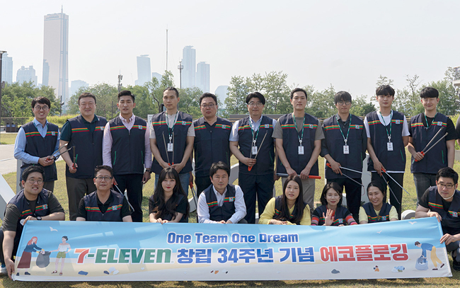 세븐일레븐 임직원들이 지난 17일 서울 한강 노들섬에서 플로깅 활동을 진행한 후 기념 사진을 찍고 있다. 세븐일레븐 제공
