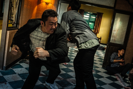 Scenes from "The Roundup," which sees Ma Dong-seok return as "the beast cop" Ma Seok-do who takes on Son in the role of a serial killer named Kang Hae-sang. [ABO ENTERTAINMENT]