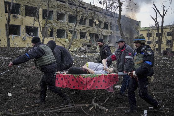 우크라이나 응급요원들이 마리우폴 내 산부인과 폭격으로 부상당한 임산부를 후송하고 있다. [AP=연합뉴스]
