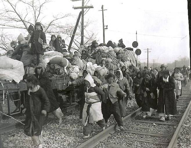 1951년 1월 4일, 1.4 후퇴 당시 남하하는 피난민들. 추운 날씨에 철길을 따라 서로 의지하며 걷고 있다/ 조선일보 자료사진